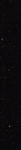 Thin horizontal Hubble image of tens of thousands of distant galaxies set against the black background of space. Most appear only as tiny dots in shades of red, orange, and white.