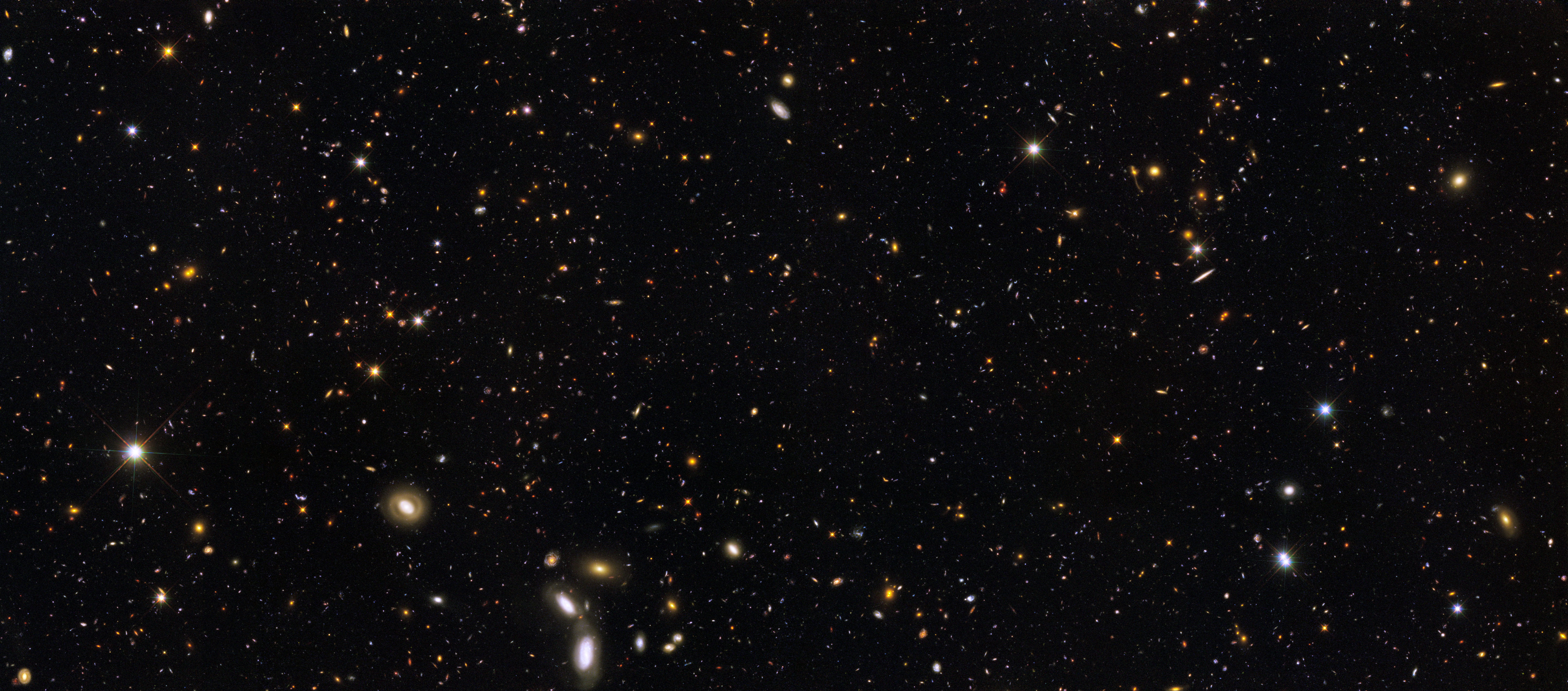 Telescope image of thousands of galaxies of different sizes, shapes, and colors.