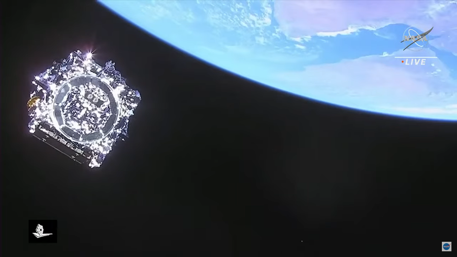View of the metallic bottom of the folded James Webb Space Telescope at top left with Earth in the background at top right.