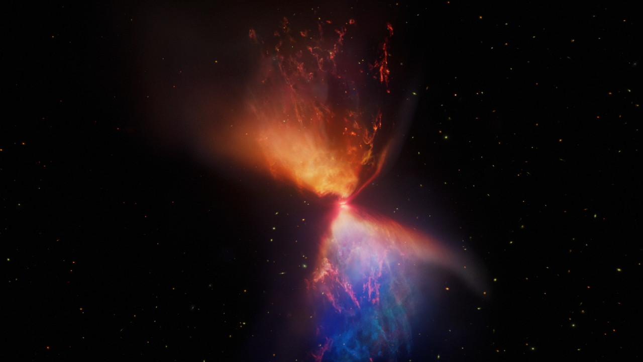 A forming protostar surrounded by a large hourglass-shaped nebula. A bright orange object, the protostar, lies at the center of this image. In front of the protostar is a thin grey line, which is the protostar’s accretion disk. Above the protostar is an orange, triangular cloud of gas that points to the top left of the image. The area closest to the protostar is a brighter orange than the area to the top left, and has more pronounced plumes of orange gas. Below the protostar is another triangular cloud of gas that points to the bottom right of the image. The area closest to the protostar is a blend of pronounced blue and orange plumes of gas. Farther toward the bottom right, the color of the gas turns primarily blue. Stars and galaxies of many different shapes and sizes are scattered around the image, although they are noticeably more absent on the left side of the hourglass.