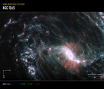 A large galaxy takes up the entirety of the image, with the lower right portion of the galaxy’s spiral arms extending off frame. The core of the galaxy is just off center to the lower right. The bright white, slightly pinkish core is not a perfect circle—it’s an elongated oval with bright, narrow, diffuse arms extending a short way out at each narrow end of the oval. The main spiral arm to the upper left of the core is wispy and highlights filaments of dust around cavernous black bubbles. Throughout, there is also a smattering of background galaxies seen as small red and greenish dots.