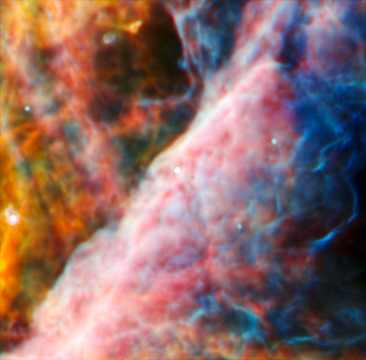 A hazy nebula made of many layers of cloudy, colourful material.