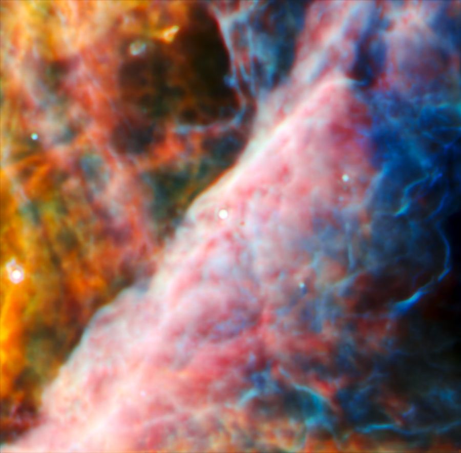 A hazy nebula made of many layers of cloudy, colourful material.