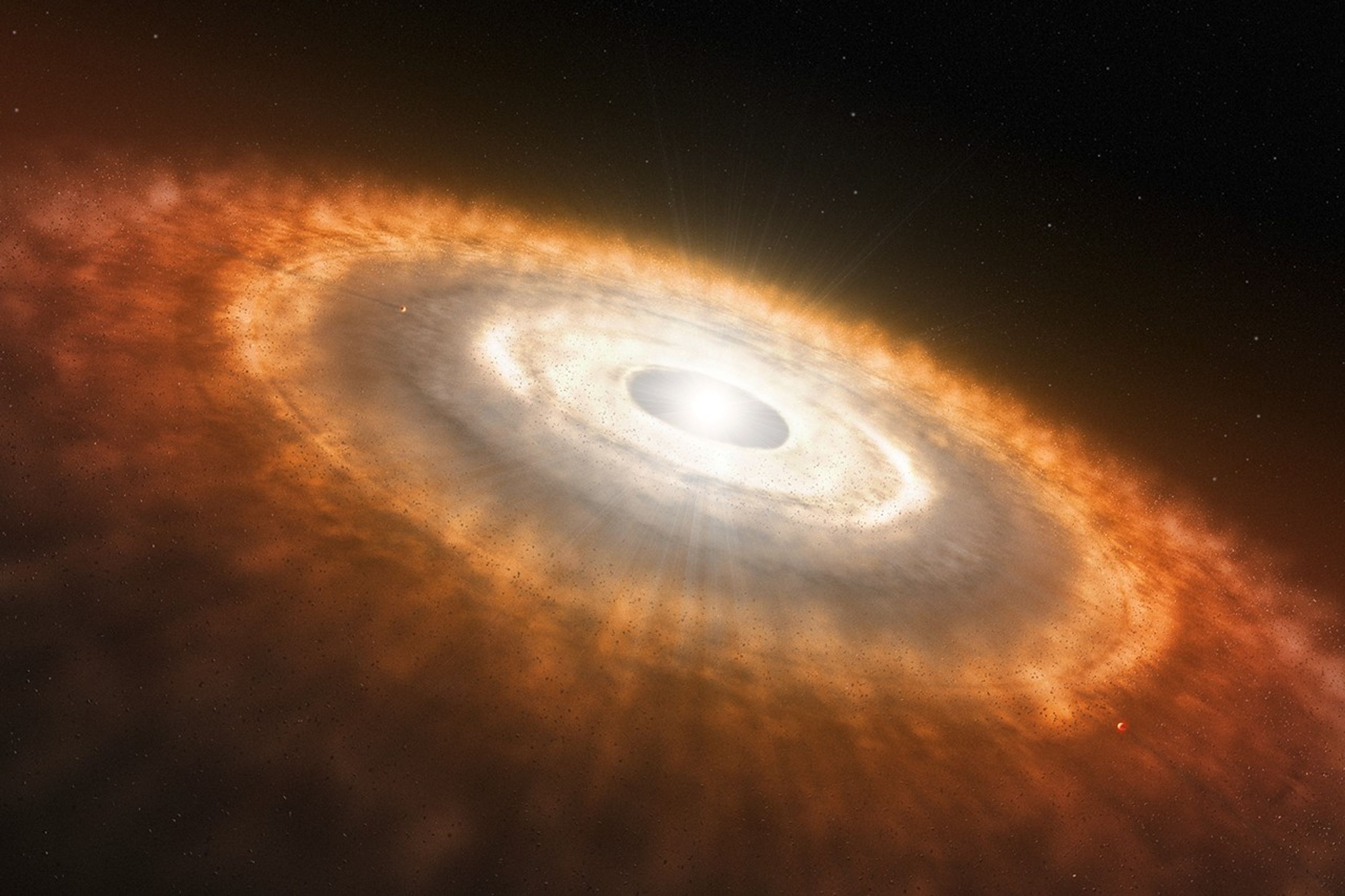 The image is dominated by a dusty disk extending from upper left to lower right and tilted toward the viewer. It resembles patchy clouds with small rocky bits scattered throughout. At 4 o’clock and 11 o’clock are two small, embedded planets. The outer edges of the disk are reddish, the middle orange, and the inner region yellow-white. At the center is a gap within which is a bright white star.