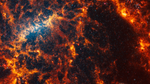 Webb’s image of NGC 5068 shows a portion of a messy face-on barred spiral galaxy in shades of white, yellow, orange, and red. The galaxy’s bar is a bright yellow arc-shaped region toward the center-left, and it is very difficult to see a spiral shape.