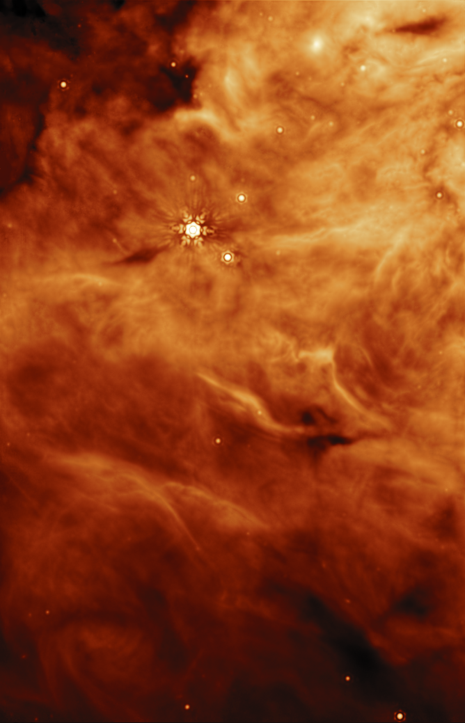 A vertical image of a region of a molecular cloud. One bright star and several dimmer stars are visible as light spots among the clouds.
