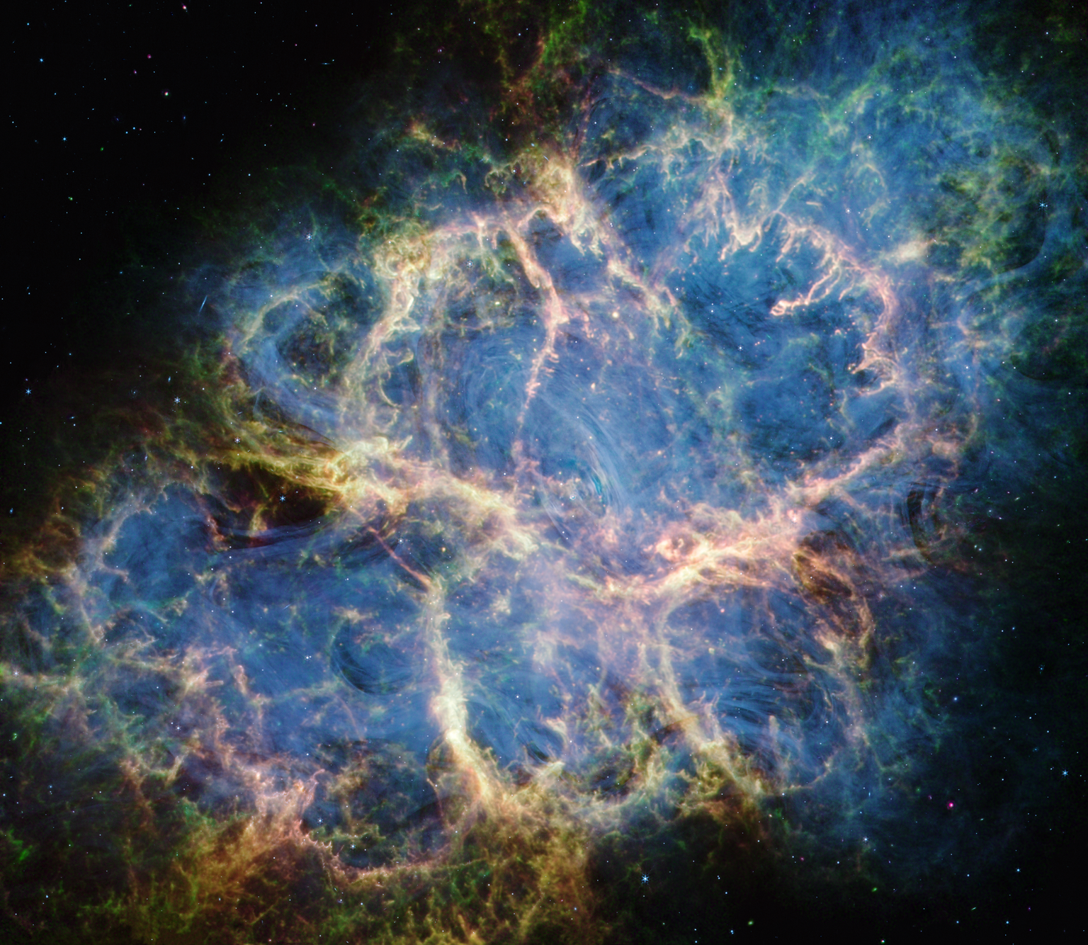 The Crab Nebula. A multicolored oval with complex structure extends from lower left to upper right against a black background.