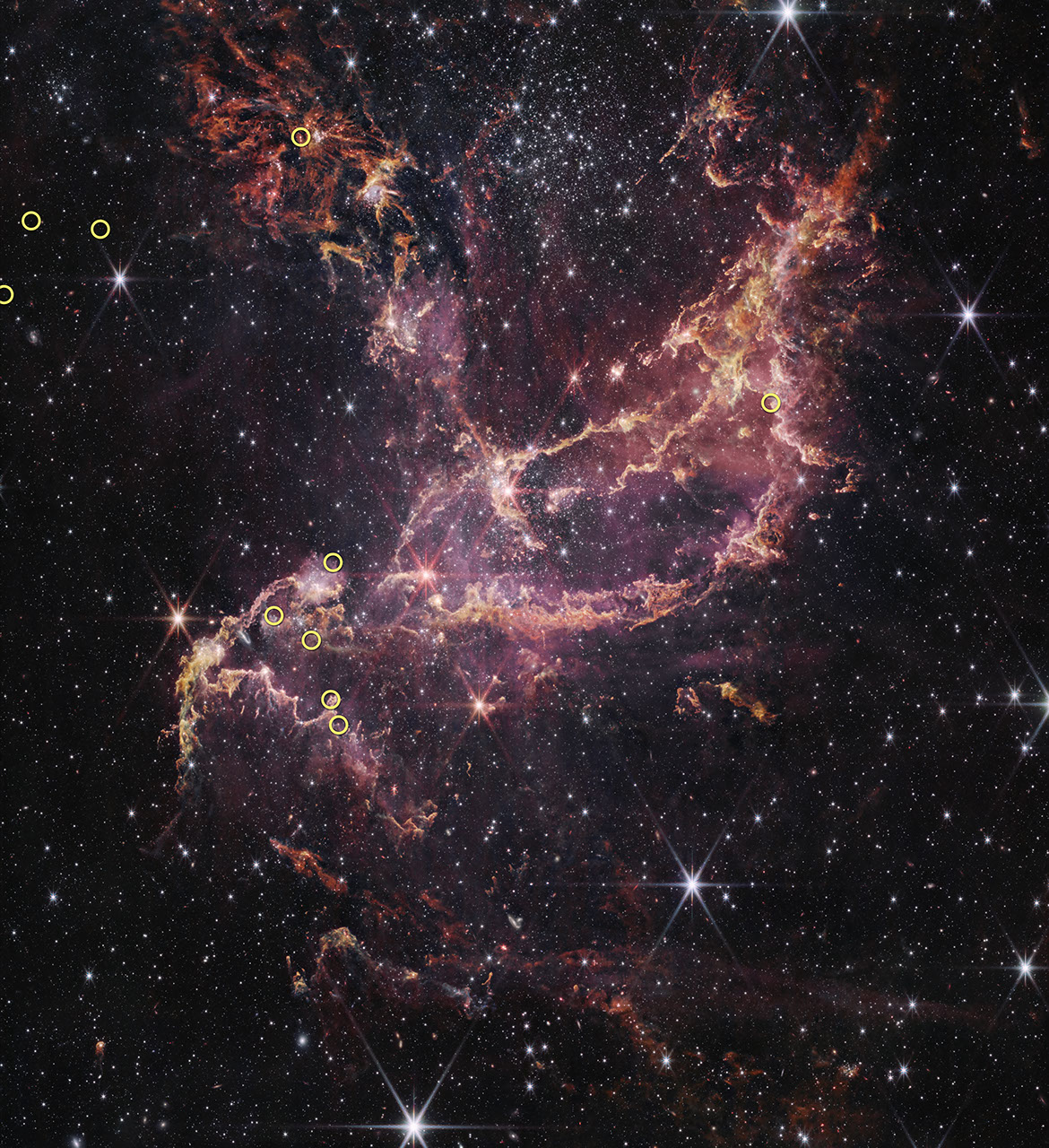 Twisted pink and orange filaments lie against a black background speckled with white and pink stars. Ten, small, yellow circles overlaid at various points across the image indicate the positions of the ten stars surveyed in this study.