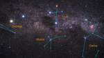 Telescope image including stars on the night sky and splotches of pink. Thin blue lines connect the actual stars of several constellations.