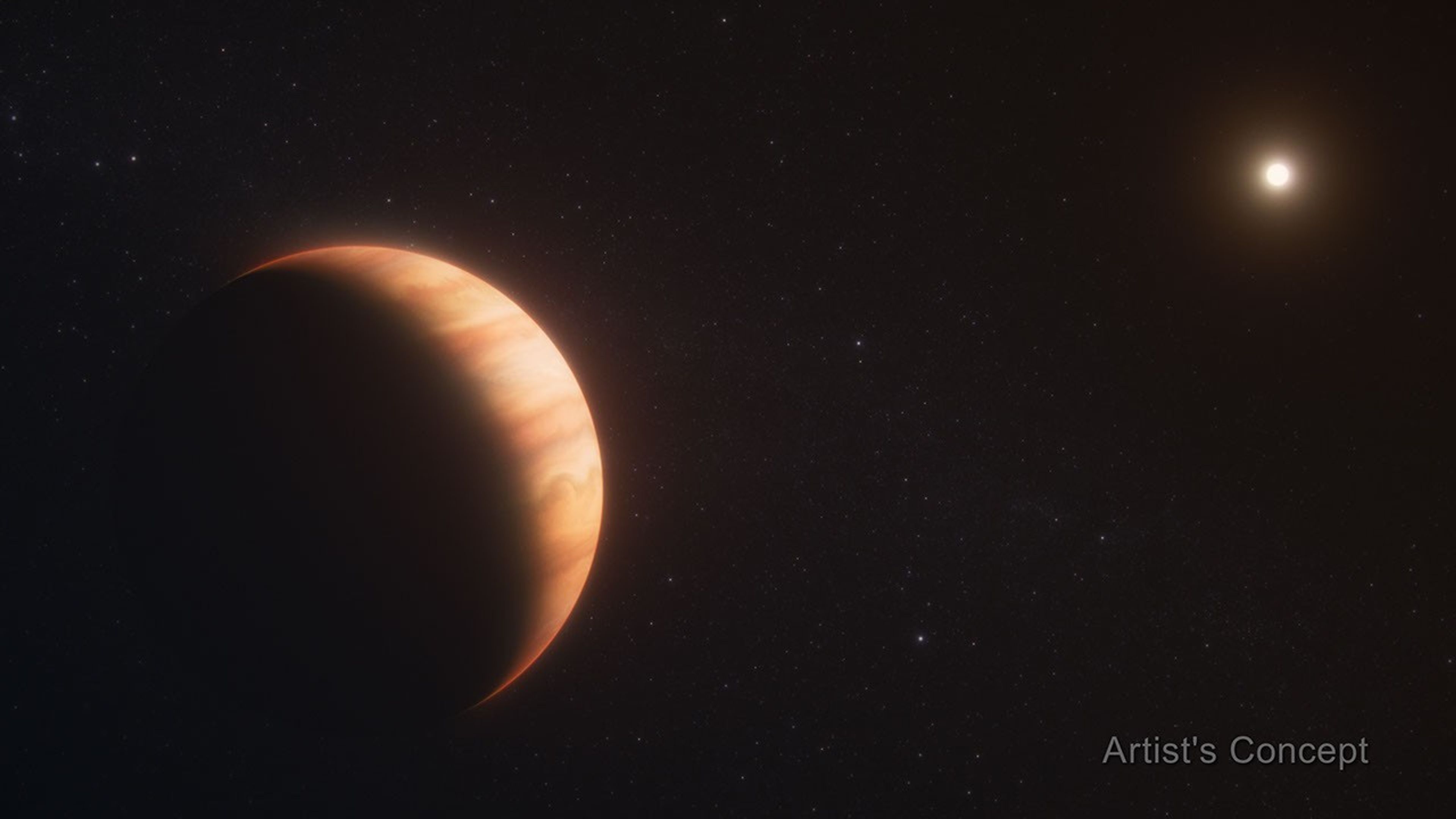 An orange gas giant planet at left, taking up about one-third of the frame, facing a star, which appears at top right as a far smaller bright dot. The planet has subtle orange cloud bands. The star illuminates the right side of the planet like the crescent of a waxing moon. Both are on the black background of space. The words “artist’s concept” are in the bottom right corner.