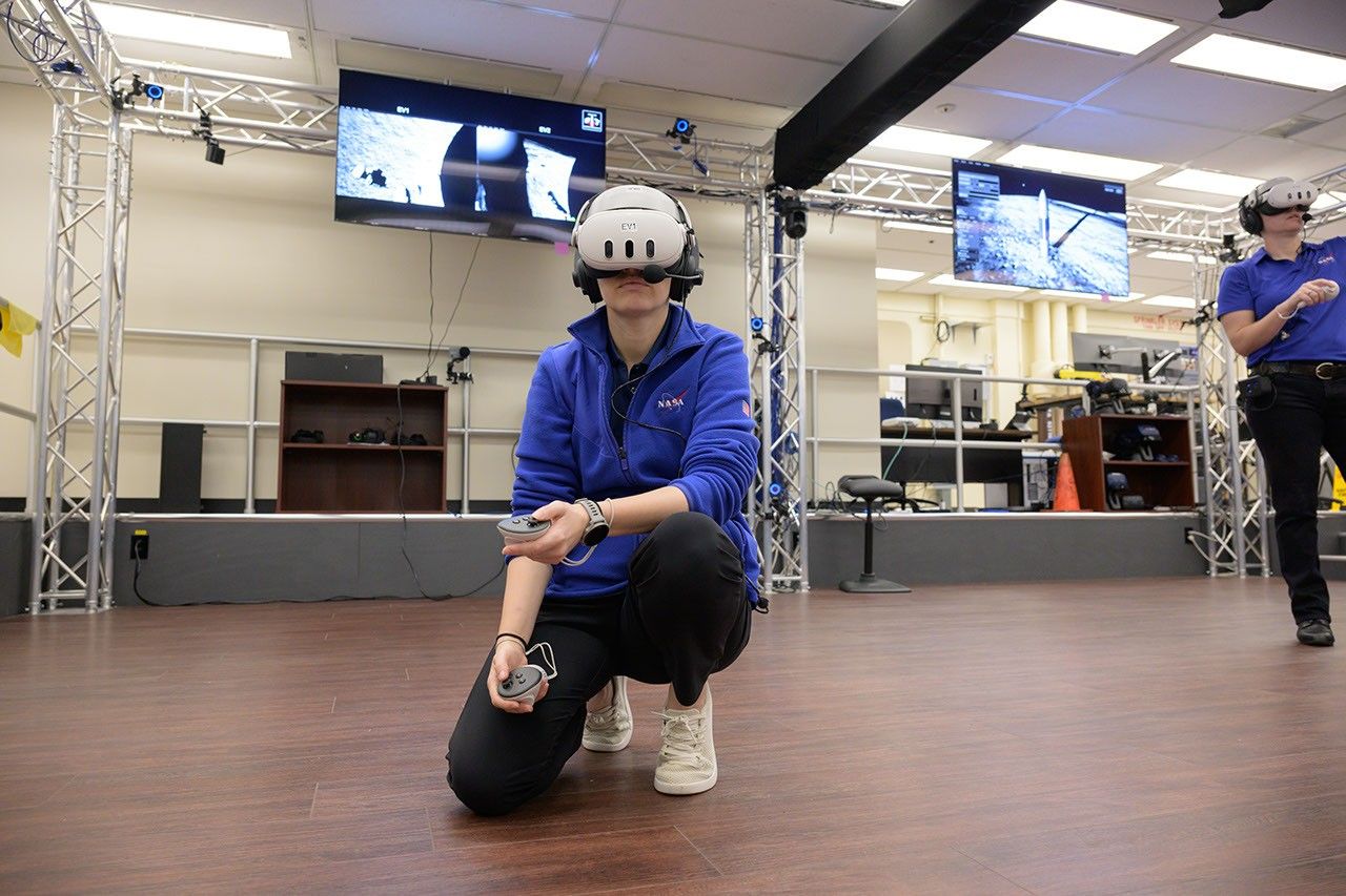 Grier Wilt, left, and Tess Caswell, crew stand-ins for the Artemis III Virtual Reality Mini-Simulation, execute a moonwalk in the Prototype Immersive Technology (PIT) lab at NASA’s Johnson Space Center in Houston. The simulation was a test of using VR as a training method for flight controllers and science teams’ collaboration on science-focused traverses on the lunar surface.