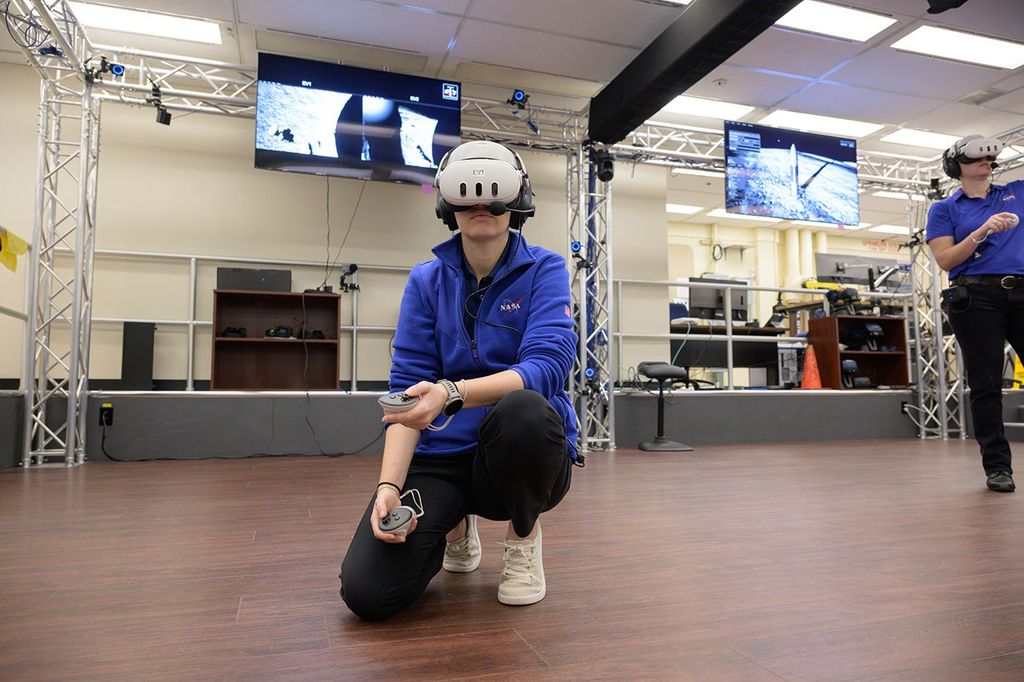 Grier Wilt, left, and Tess Caswell, crew stand-ins for the Artemis III Virtual Reality Mini-Simulation, execute a moonwalk in the Prototype Immersive Technology (PIT) lab at NASA’s Johnson Space Center in Houston. The simulation was a test of using VR as a training method for flight controllers and science teams’ collaboration on science-focused traverses on the lunar surface.