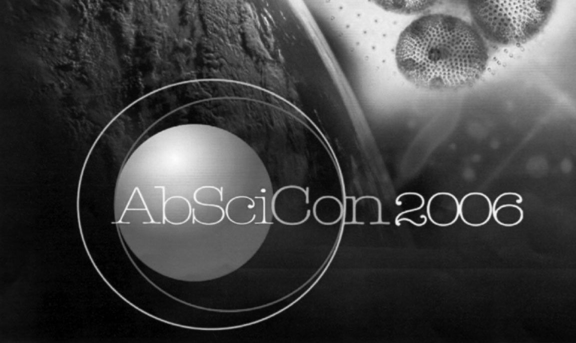 The logo is shown in black and white. The background is a dark image of the surface of Mars to the left and computer renditions of cells interacting to the right. Above this sits a grey orb representing a planet with to light rings around it. Above this reads "AbSciCon 2006."