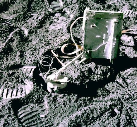 An instrument with wiring coming out of it sitting on the surface of the Earth's Moon. Also seen nearby are foot prints from the astronauts from the Apollo mission. 