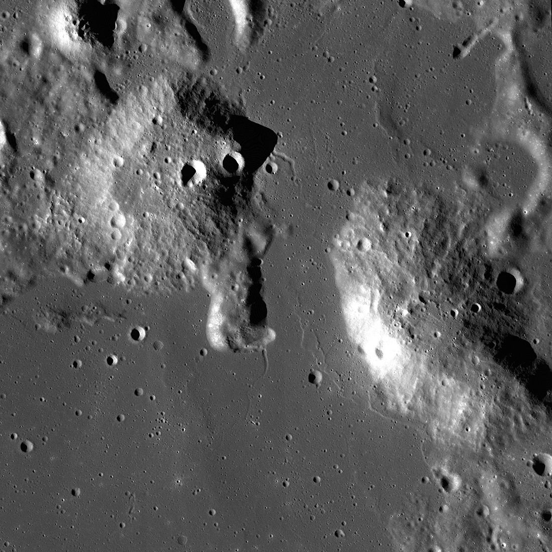 Cratered volcanic hills protrude outward from the surrounding lunar terrain. The Gruithuisen Domes were formed by eruptions of silicic lavas, which didn't flow outward easily, creating domes.