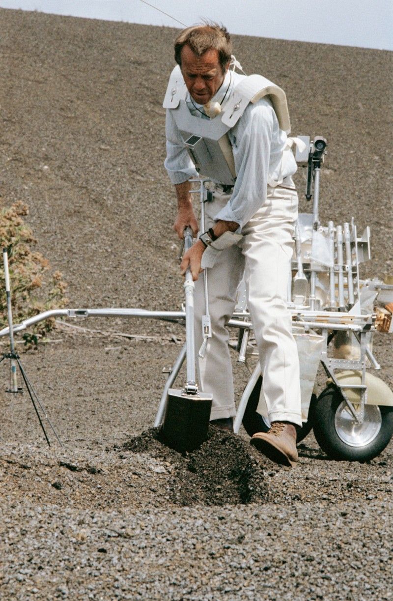 Astronaut digs on a sandy slope during traverse simulation