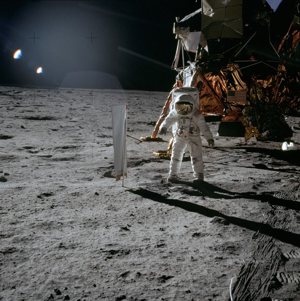 Astronaut and lunar module on surface of Moon