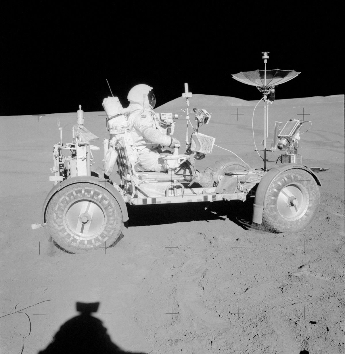 Astronaut driving rover on the Moon