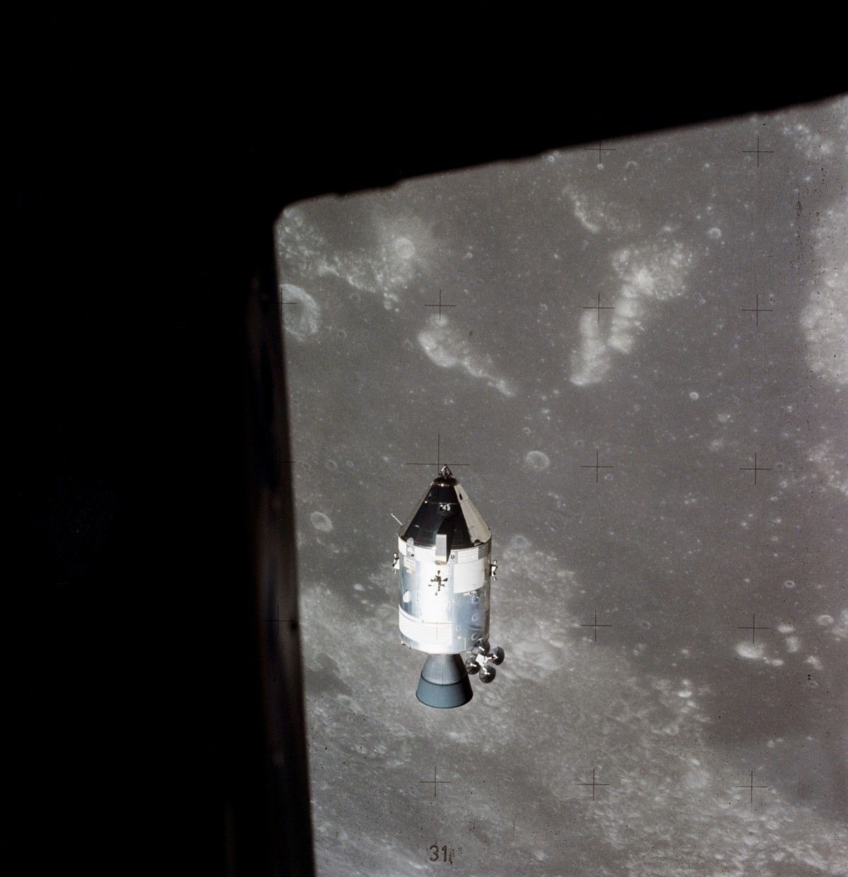 Apollo 15 in lunar orbit, with the surface of the Moon visible in the background. 