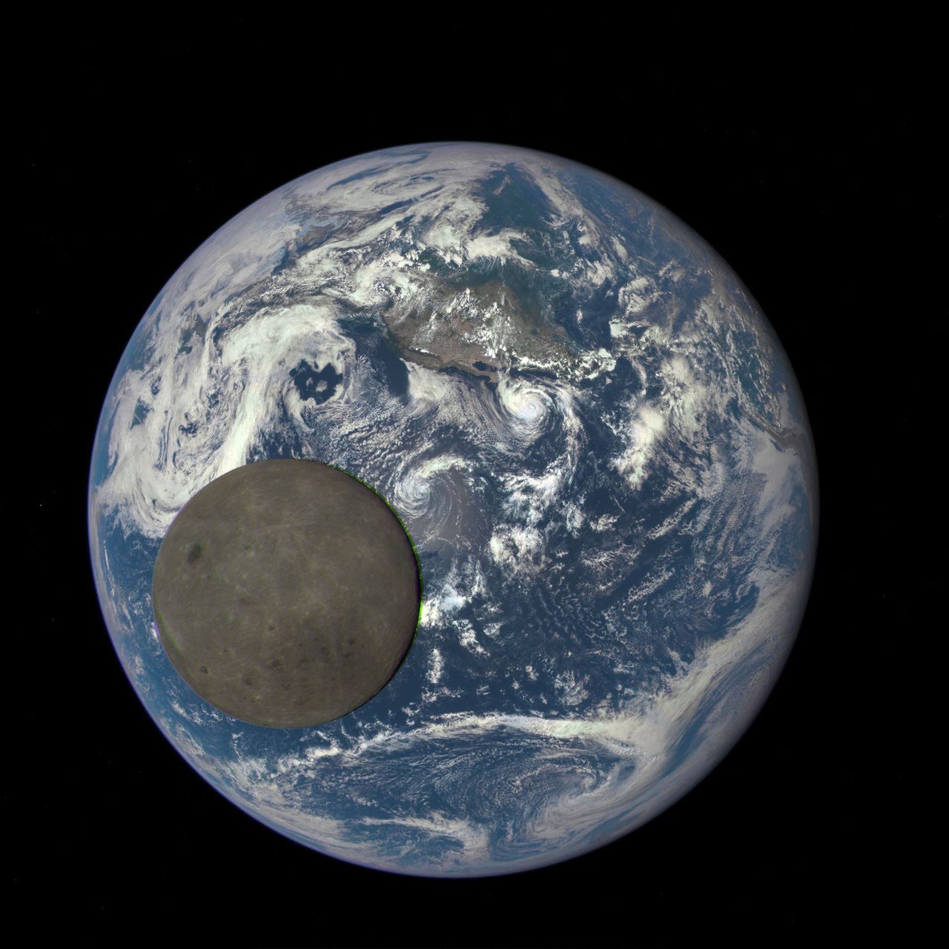 Dark grey Moon passing in front of Earth. The Moon's diameter appears to be about 1/3 of Earth's from this point of view.
