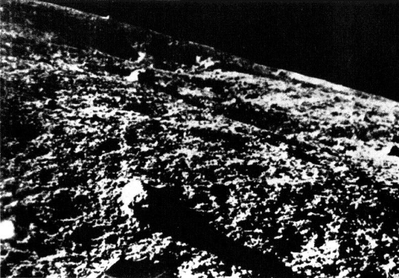 Grainy black and white photo of the moon.