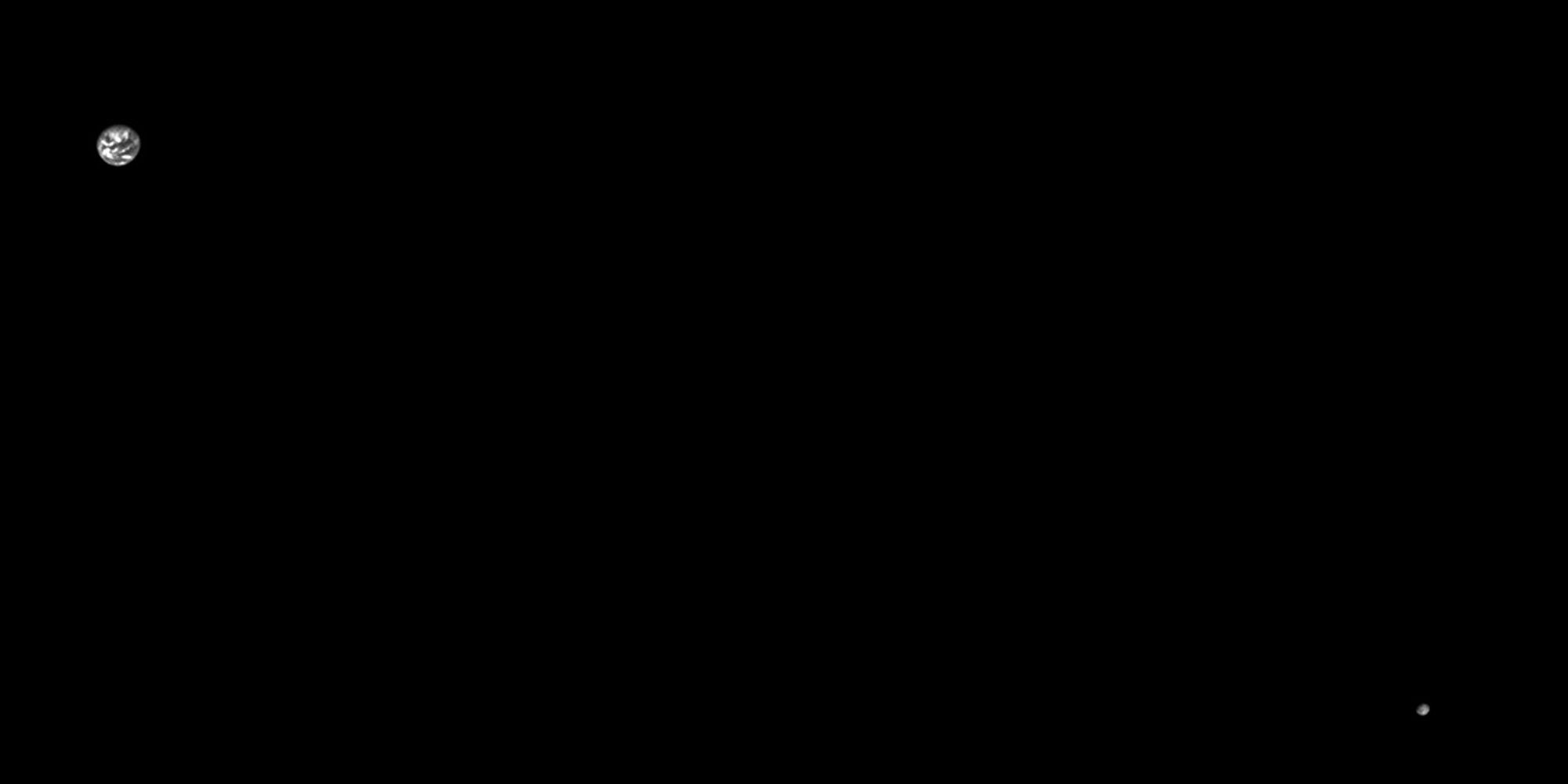 Black and white image of Earth and the Moon, both seen from a distance.