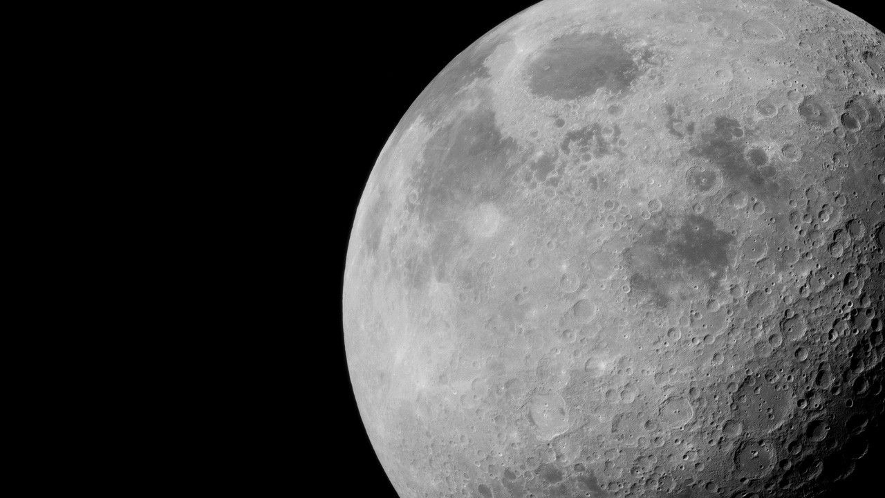 the Moon, up close against a black sky, fills the right-hand side of the image.