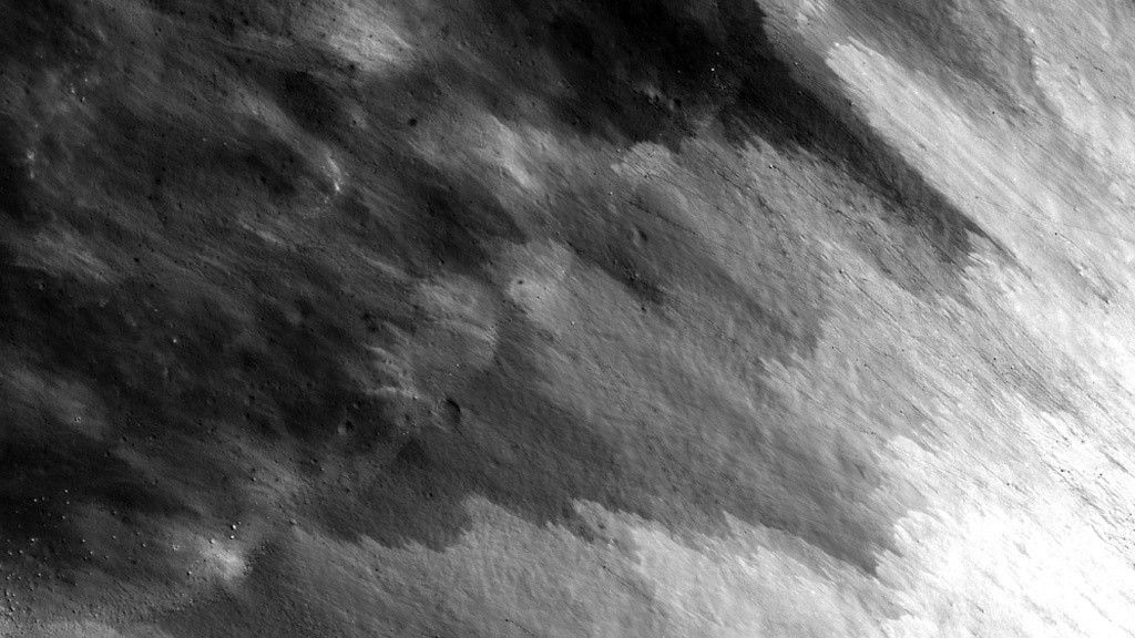 Overlapping streaks of debris extending from the bottom right, growing darker towards the upper left.