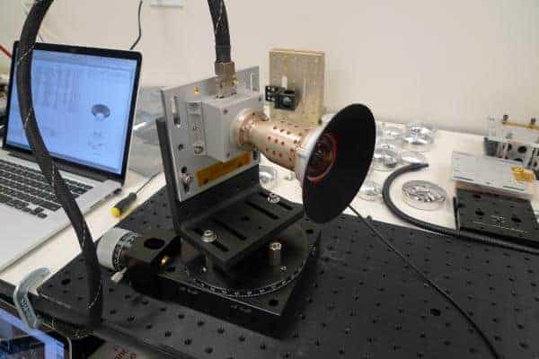 The panoramic imager camera, which looks a bit like a megaphone, is mounted in a laboratory undergoing testing. It is wired to a laptop computer that appears in the background.