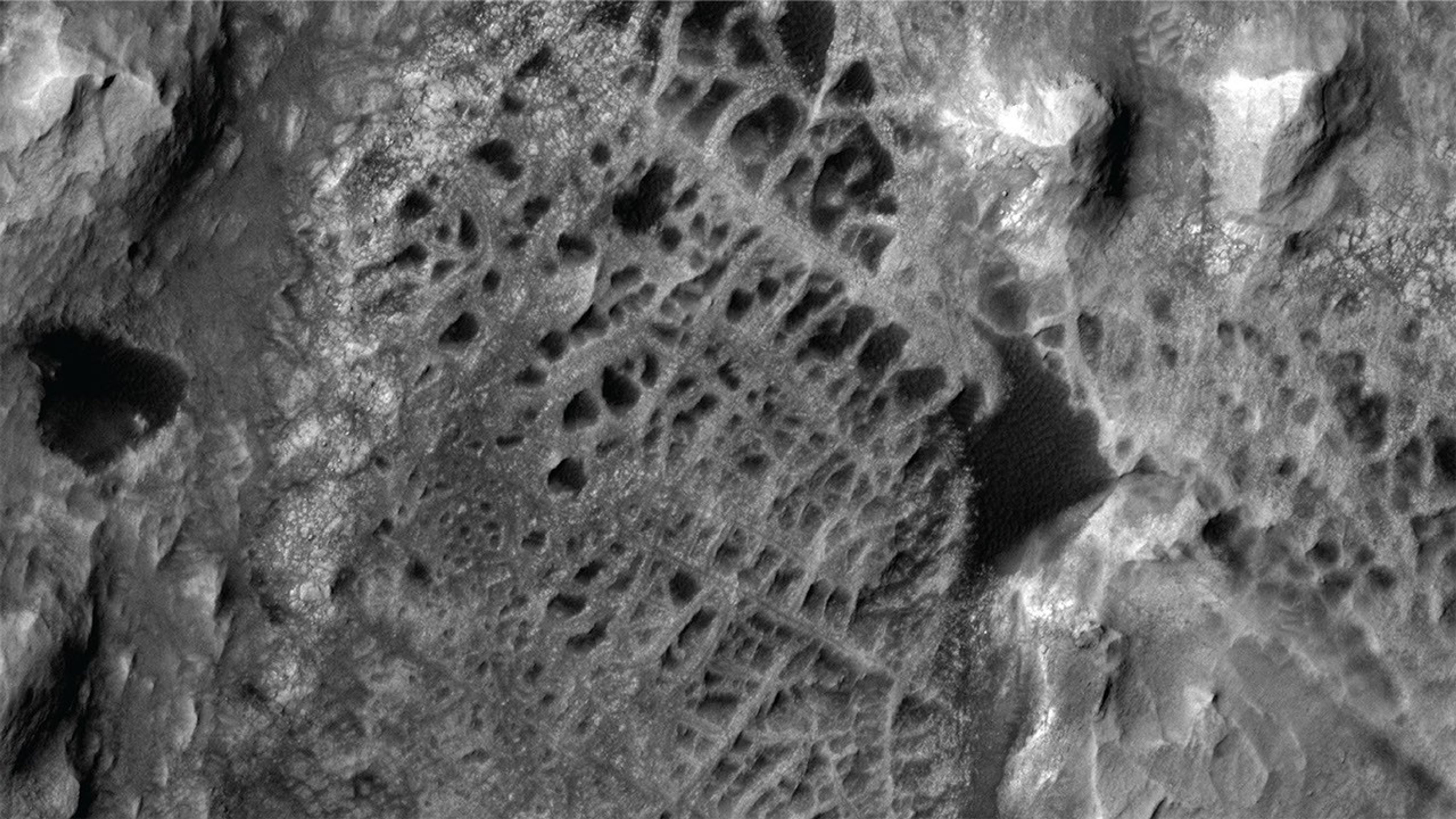 Rugged Martian terrain viewed from orbit.