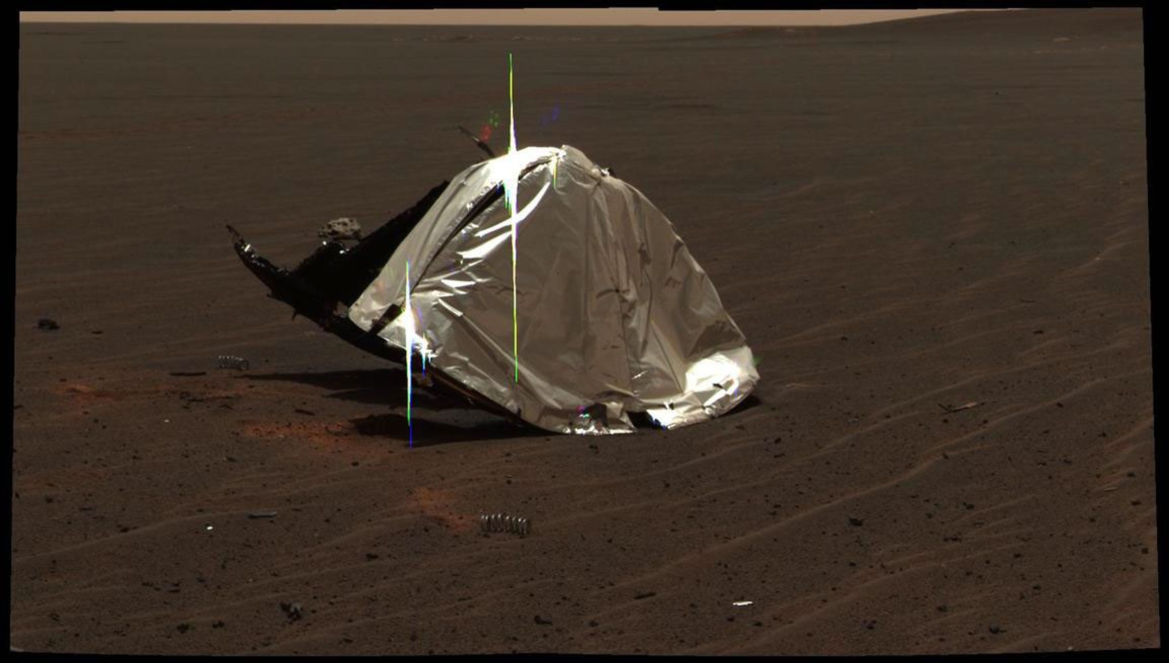 This image from Opportunity's panoramic camera features the remains of the heat shield that protected the rover from temperatures of up to 2,000 degrees Fahrenheit as it made its way through the martian atmosphere.