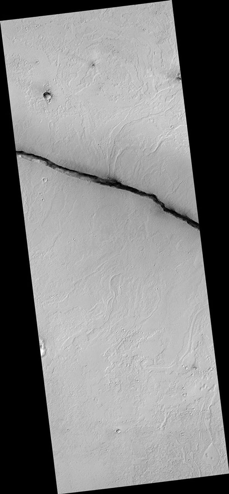The linearity of the volcanic vent shown in this HiRISE image, in conjunction with evidence of lava flow from the vent, suggests control by combined volcano-tectonic processes. The details of this vent gained by HiRISE should provide insight into those volcano-tectonic processes along Cerberus Fossae fissures in two ways.