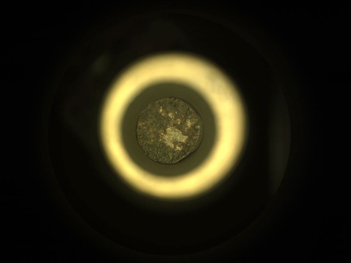 NASA's Mars Perseverance rover acquired this image using its onboard Sample Caching System Camera (CacheCam), located inside the rover underbelly. It looks down into the top of a sample tube to take close-up pictures of the sampled material and the tube as it's prepared for sealing and storage.