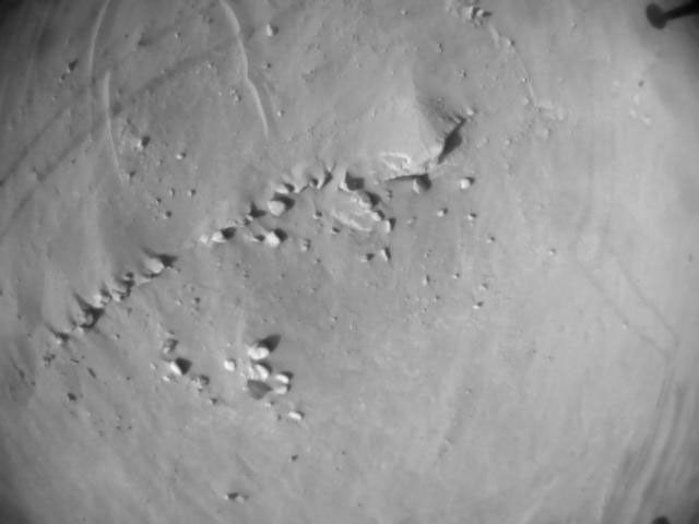 NASA's Ingenuity Mars Helicopter acquired this image using its navigation camera. This camera is mounted in the helicopter's fuselage and pointed directly downward to track the ground during flight.