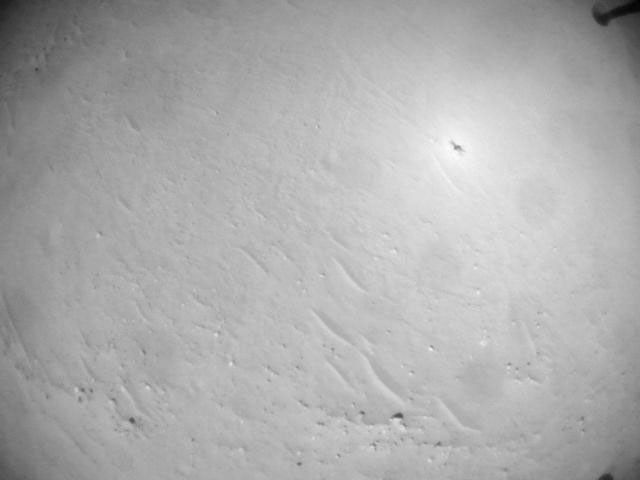 NASA's Ingenuity Mars Helicopter acquired this image using its navigation camera. This camera is mounted in the helicopter's fuselage and pointed directly downward to track the ground during flight.