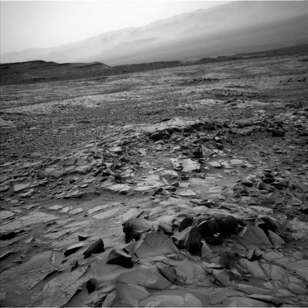 Slightly closer, we can also see the distinctly layered nature of Gediz Vallis Ridge, which sits on top of the pediment and is one of the youngest geomorphic features on Mt. Sharp, to the left of this image.