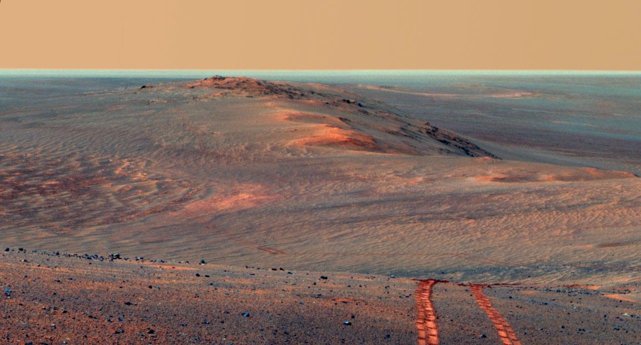 This scene from the panoramic camera on NASA's Mars Exploration Rover Opportunity looks back toward part of the west rim of Endeavour Crater that the rover drove along, heading southward, during the summer of 2014.
