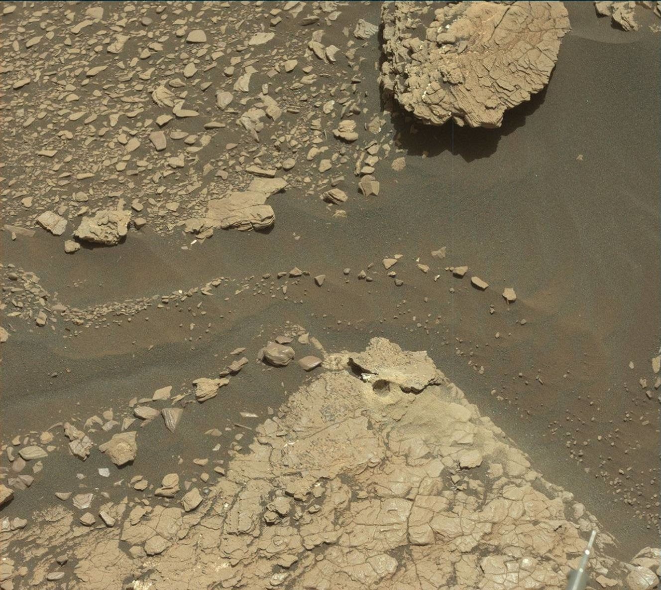 a drill hole at the center of the image with fractured rocks around it.
