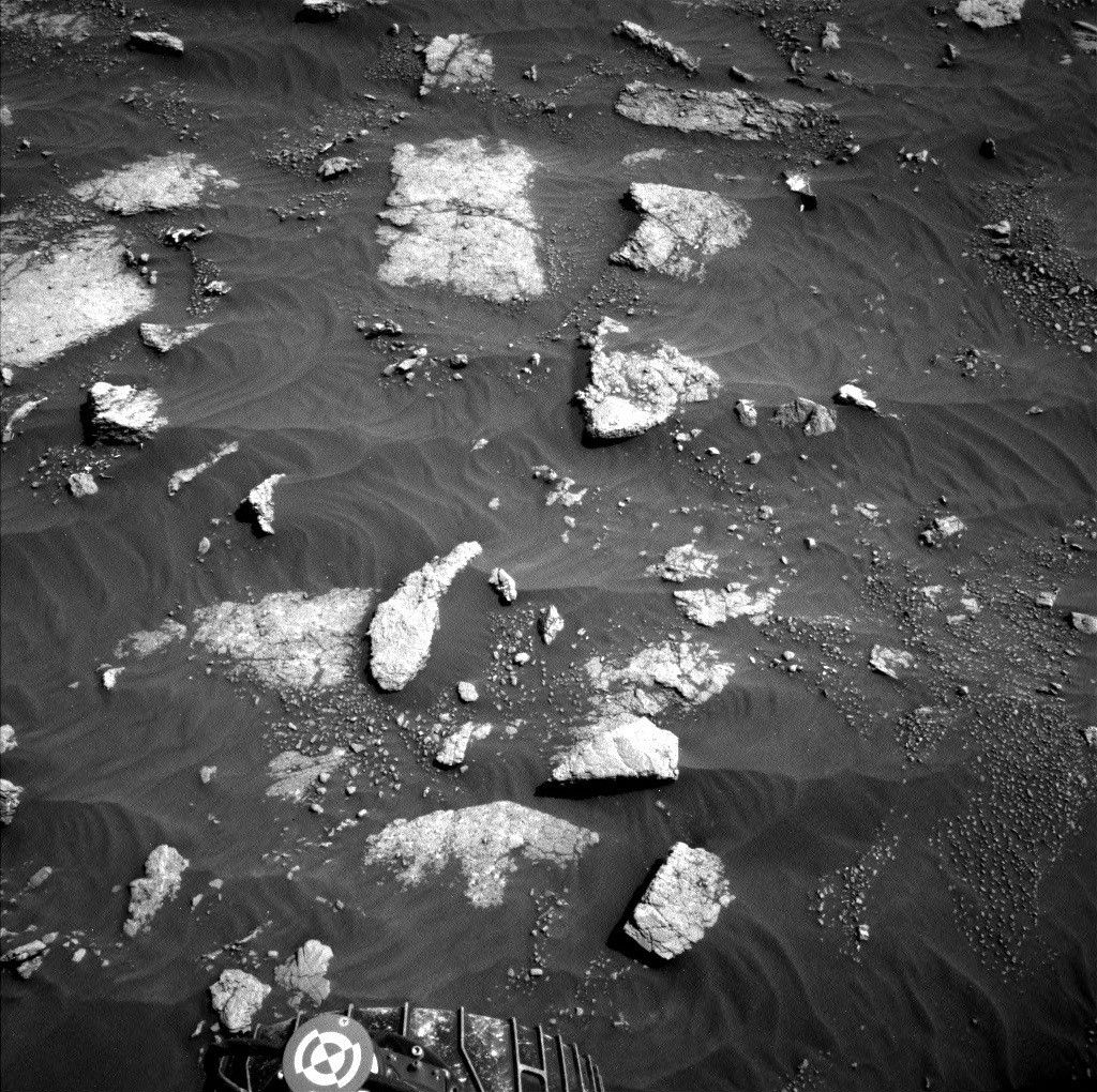 One of Curiosity's wheels is visible on this image of Mars