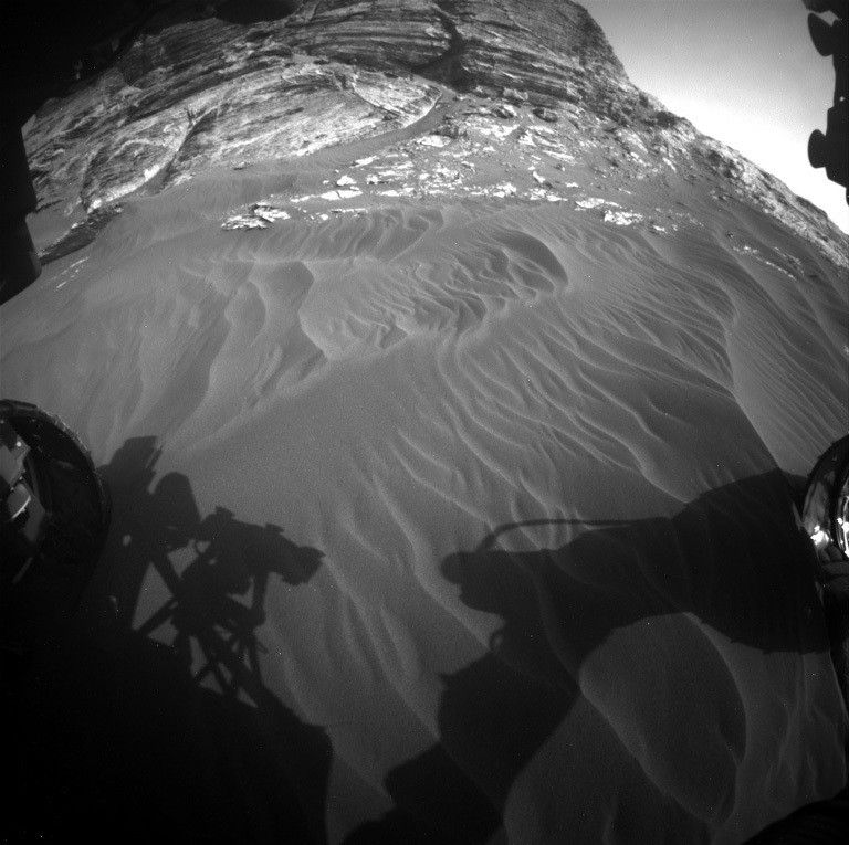 A patch of sand and a 7-meter outcrop on mars