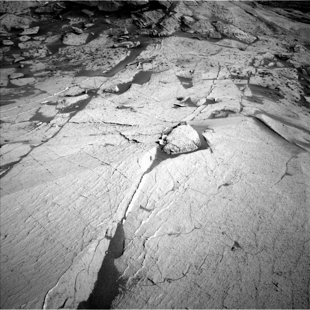 This black and white image shows the sandy surface with cracks.