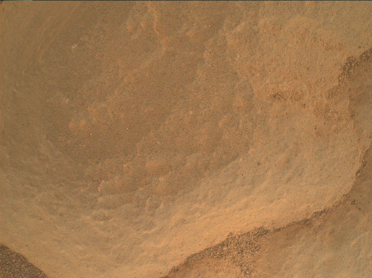 A MAHLI image taken from ~5 cm standoff from a pediment cap rock in the “Hartle Loup” exposure showing a white grain on the face in the top left.