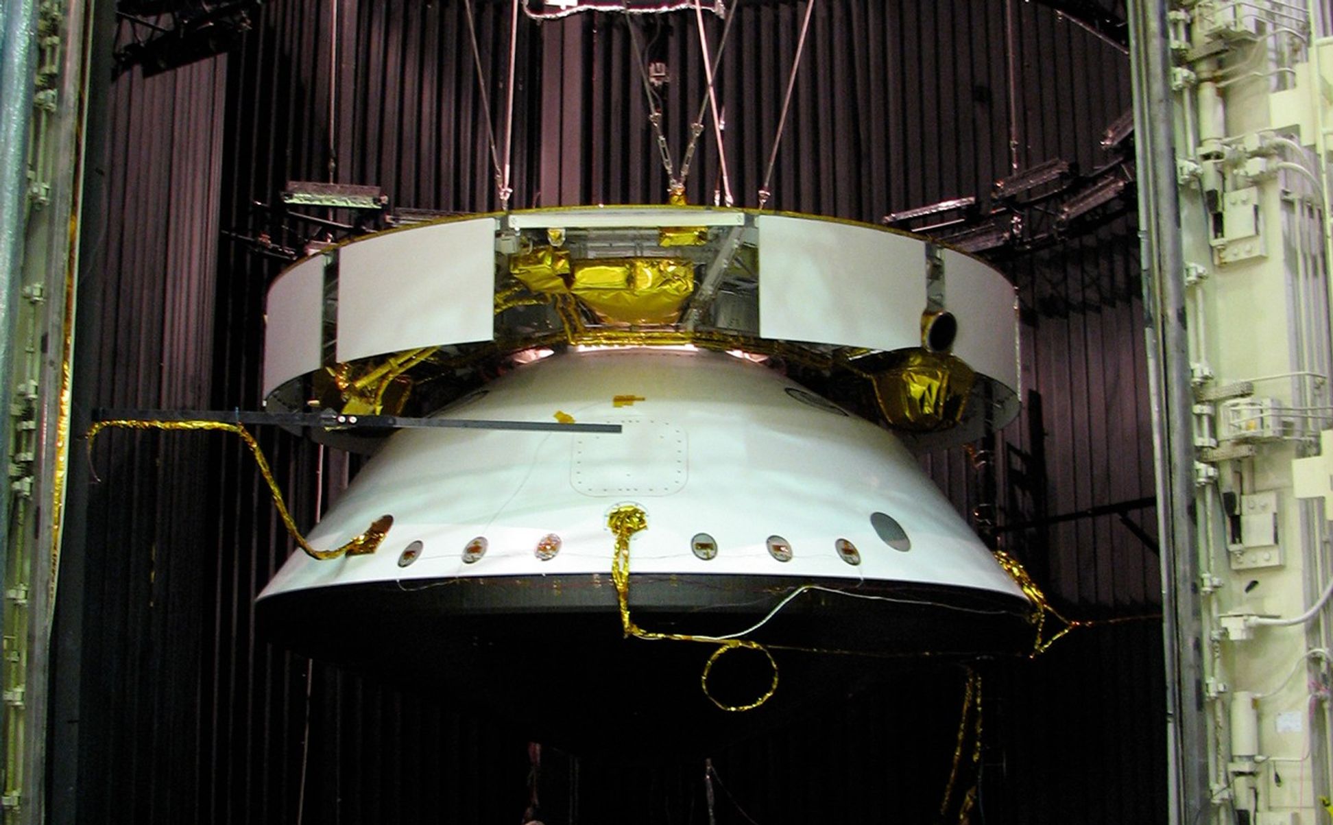 This image shows the Mars Science Laboratory spacecraft is suspended in a dark chamber, awaiting an environmental test.