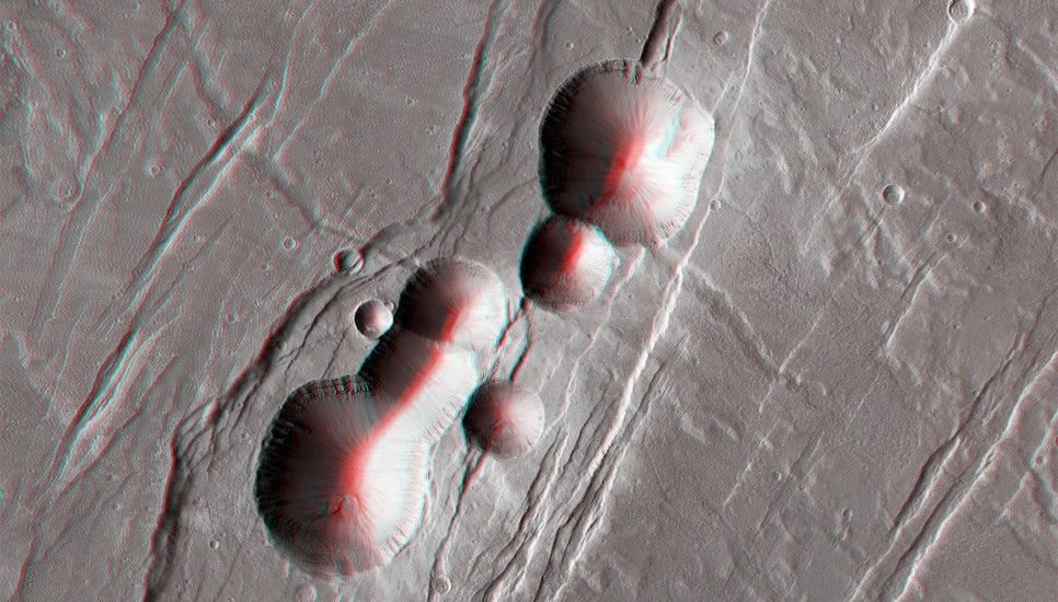 This chain of collapse pits located on the southeast flank of Alba Patera, a volcanic complex, probably formed when empty underground lava tubes collapsed.