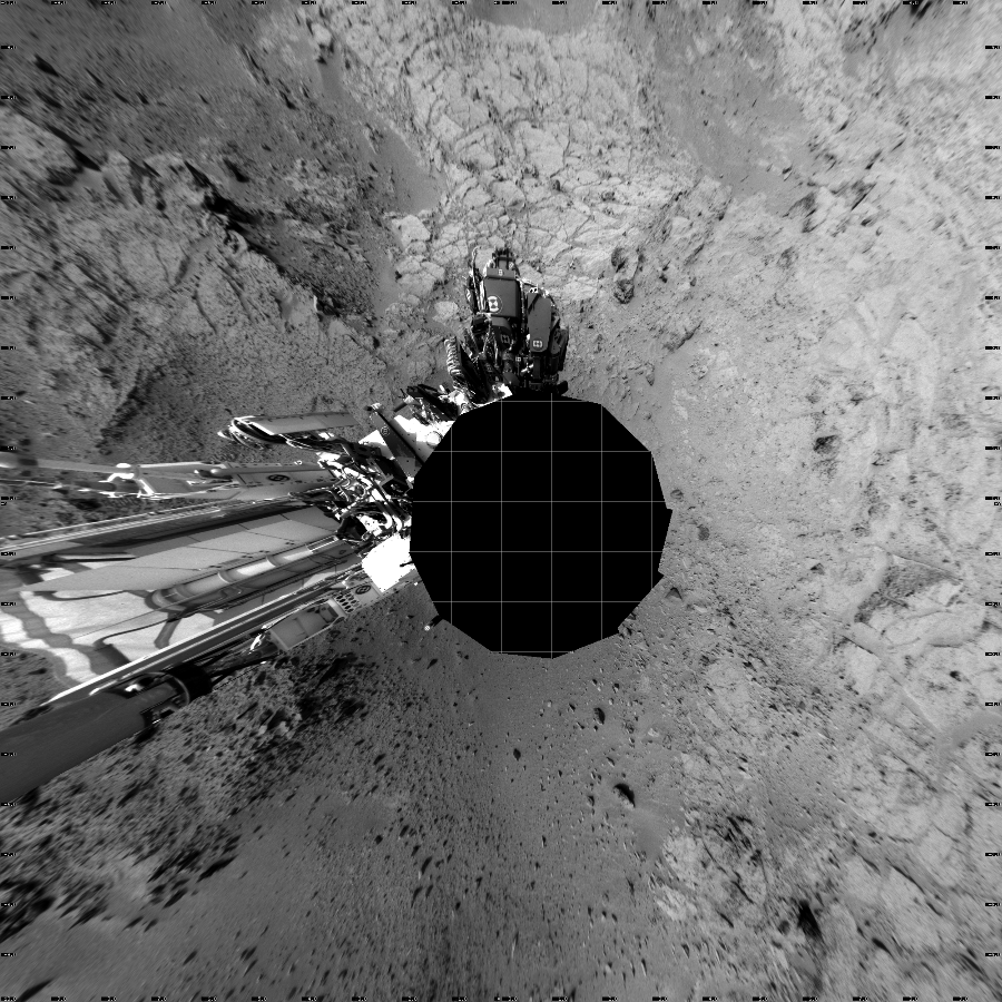 NASA's Mars rover Curiosity took 12 images in Gale Crater using its mast-mounted Left Navigation Camera (Navcam) to create this mosaic. The seam-corrected mosaic provides a vertical projection of the Martian surface near the rover, covering an area of 20 meters (north/south) by 20 meters (east/west). North is up in the image. This projection provides an overhead view, but introduces distortion for items not on the surface, such as large rocks and the rover itself.  Curiosity took the images on December 05, 2012, Sol 118 of the Mars Science Laboratory mission at drive 432, site number 5. The local mean solar time for the image exposures was 2 PM. Each Navcam image has a 45-degree field of view. CREDIT: NASA/JPL-Caltech
