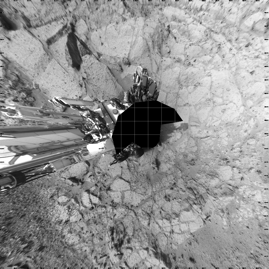NASA's Mars rover Curiosity took 17 images in Gale Crater using its mast-mounted Left Navigation Camera (Navcam) to create this mosaic. The seam-corrected mosaic provides a vertical projection of the Martian surface near the rover, covering an area of 20 meters (north/south) by 20 meters (east/west). North is up in the image. This projection provides an overhead view, but introduces distortion for items not on the surface, such as large rocks and the rover itself.  Curiosity took the images on December 10, 2012, Sol 122 of the Mars Science Laboratory mission at drive 938, site number 5. The local mean solar time for the image exposures was 3 PM. Each Navcam image has a 45-degree field of view. CREDIT: NASA/JPL-Caltech