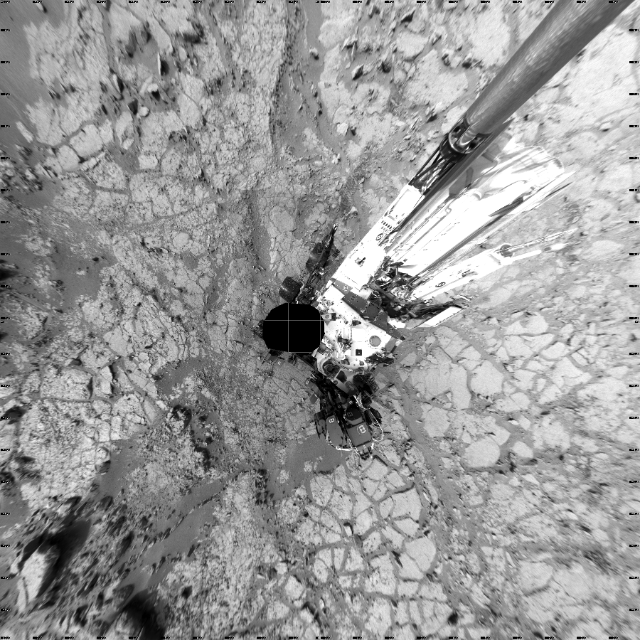 NASA's Mars rover Curiosity took 24 images in Gale Crater using its mast-mounted Left Navigation Camera (Navcam) to create this mosaic. The seam-corrected mosaic provides a vertical projection of the Martian surface near the rover, covering an area of 20 meters (north/south) by 20 meters (east/west). North is up in the image. This projection provides an overhead view, but introduces distortion for items not on the surface, such as large rocks and the rover itself.  Curiosity took the images on December 21, 2012, Sols 133-134 of the Mars Science Laboratory mission at drive 1858, site number 5. The local mean solar time for the image exposures was from 2 PM to 5 PM. Each Navcam image has a 45-degree field of view. CREDIT: NASA/JPL-Caltech