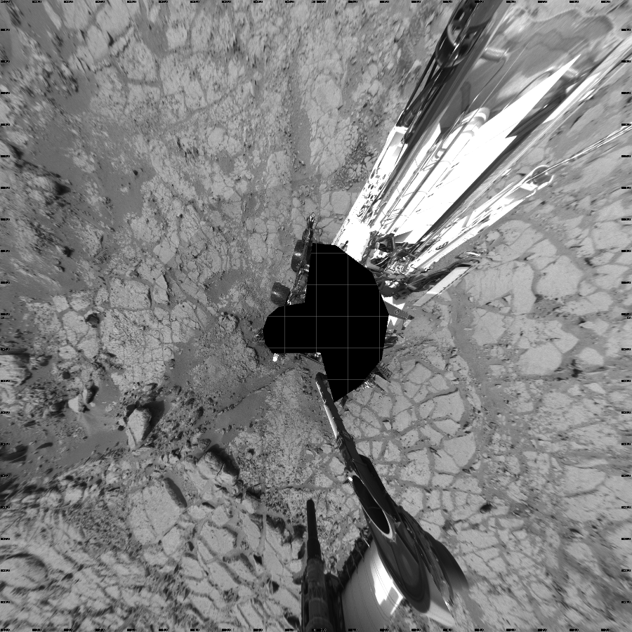 NASA's Mars rover Curiosity took 18 images in Gale Crater using its mast-mounted Left Navigation Camera (Navcam) to create this mosaic. The seam-corrected mosaic provides a vertical projection of the Martian surface near the rover, covering an area of 20 meters (north/south) by 20 meters (east/west). North is up in the image. This projection provides an overhead view, but introduces distortion for items not on the surface, such as large rocks and the rover itself.  Curiosity took the images on January 04, 2013, Sol 147 of the Mars Science Laboratory mission at drive 1902, site number 5. The local mean solar time for the image exposures was from 1 PM to 2 PM. Each Navcam image has a 45-degree field of view. CREDIT: NASA/JPL-Caltech