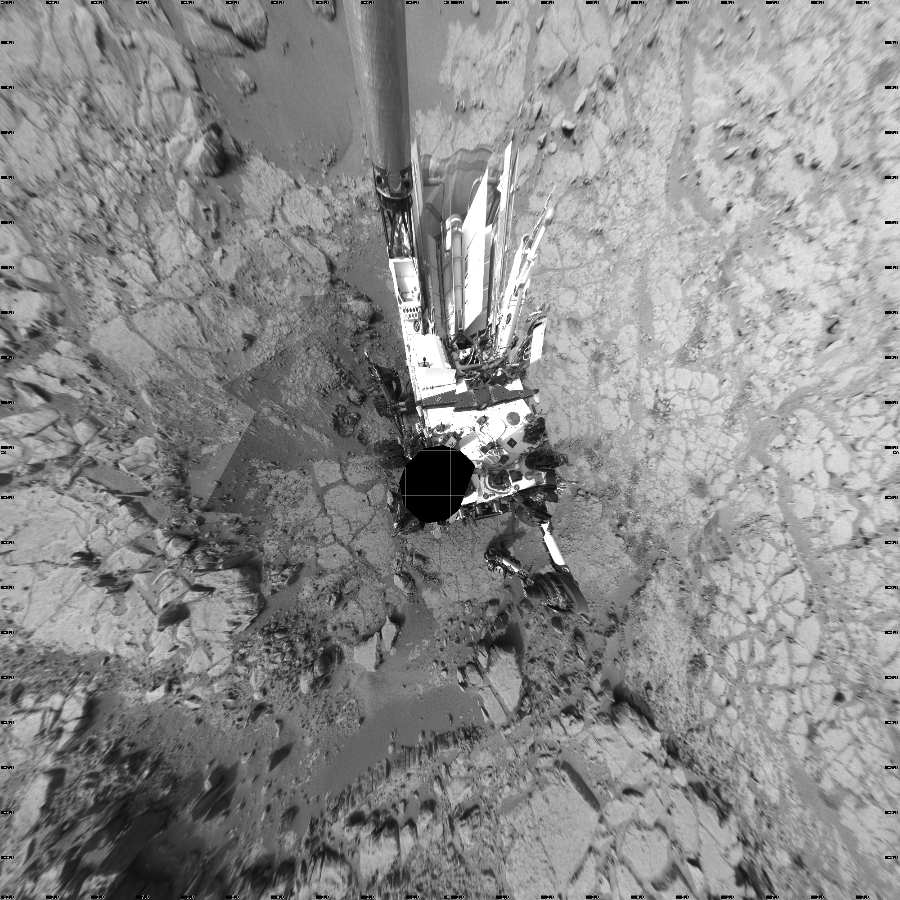 NASA's Mars rover Curiosity took 40 images in Gale Crater using its mast-mounted Left Navigation Camera (Navcam) to create this mosaic. The seam-corrected mosaic provides a vertical projection of the Martian surface near the rover, covering an area of 20 meters (north/south) by 20 meters (east/west). North is up in the image. This projection provides an overhead view, but introduces distortion for items not on the surface, such as large rocks and the rover itself.  Curiosity took the images on January 26, 2013, Sols 168-169 of the Mars Science Laboratory mission at drive 0, site number 6. The local mean solar time for the image exposures was from 3 PM to 4 PM. Each Navcam image has a 45-degree field of view. CREDIT: NASA/JPL-Caltech