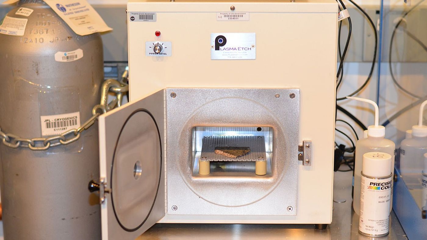 rock visible in open door of machine